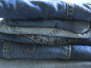 pile of denim jeans for upcycling projects